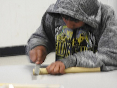 Student Making a Flute