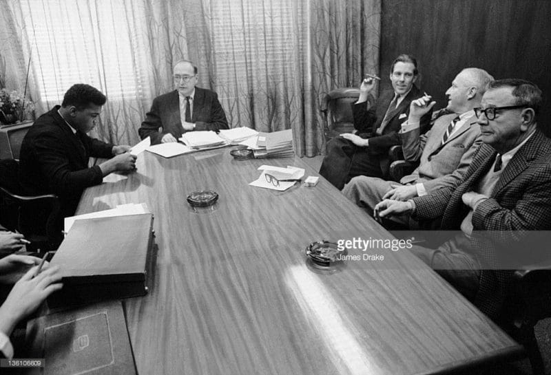 Boxer Cassius Clay (Muhammad Ali) meeting with his promoters, the Louisville Sponsoring Group, in Louisville, Kentucky, 1963. (Photo by James Drake/The LIFE Images Collection/Getty Images). Worth Bingham is third from left, holding a cigar.