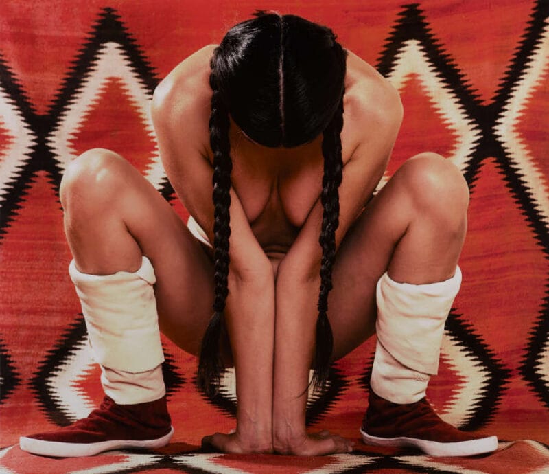 Photograph of nude Native American woman crouching