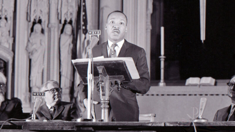 Martin Luther King Jr speaking behind podium