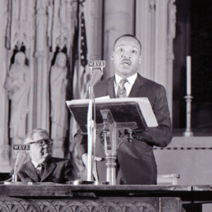 Martin Luther King Jr speaking behind podium