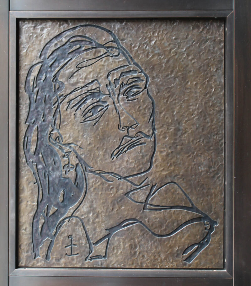 Drawing of a woman's face in bronze