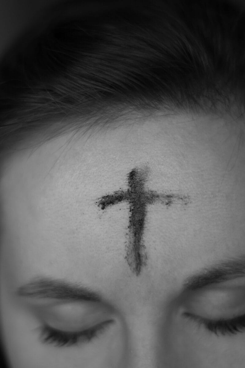 Photo of cross of ashes on woman's forehead