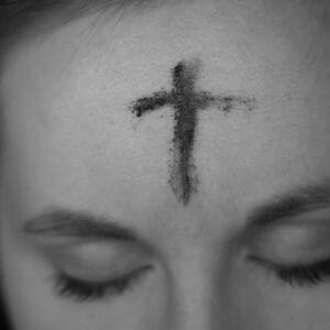 Photo of cross of ashes on woman's forehead