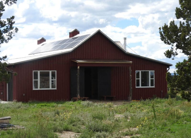 Photo of red barn with solar panels