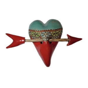 Ceramic wall sculpture of a heart with an arrow through it