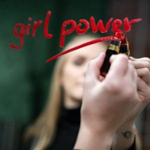 Photo of writing "Girl Power" on a mirror with lipstick
