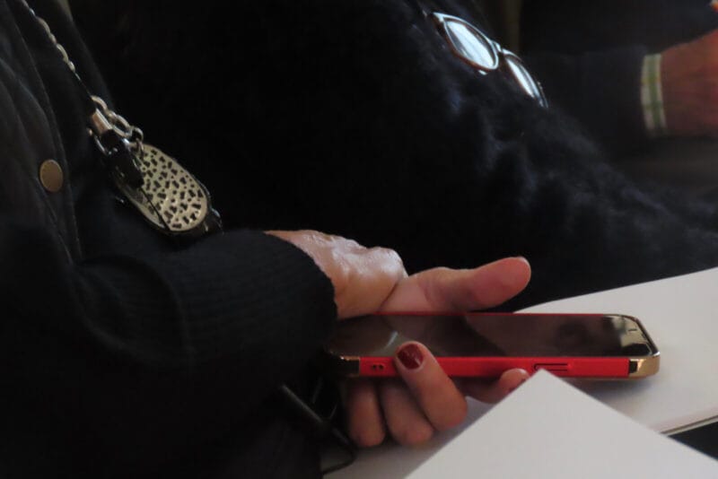 Photo of an elderly woman's hands holding a phone