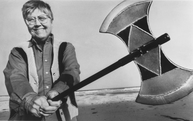 Photo of feminist Mary Daly holding an axe