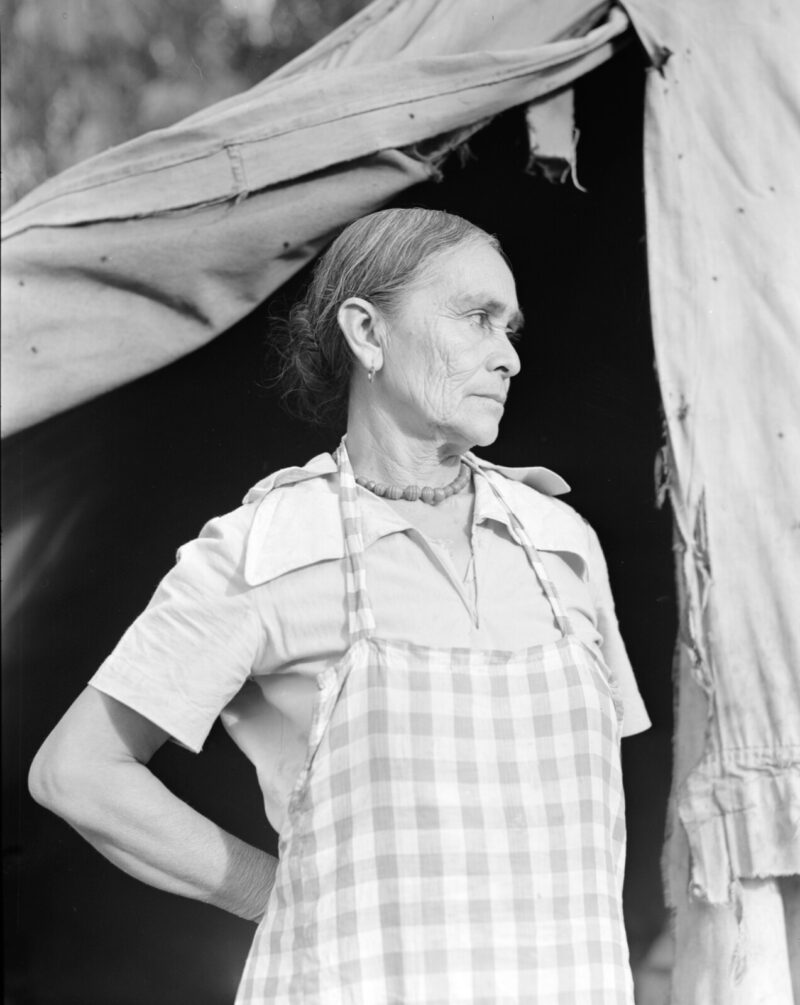 Black and white photo of migrant woman in tent