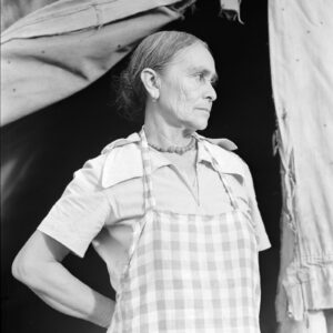 Black and white photo of migrant woman in tent