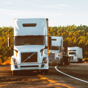Photo of semi-trailer trucks parked off highway