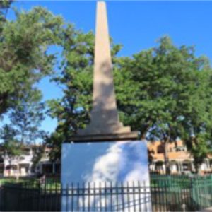 Photo of the Santa Fe Plaza obelisk, base covered with plywood