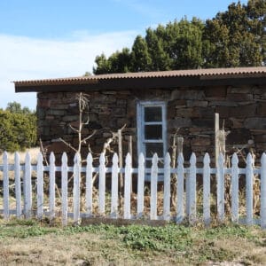 Photo of rock studio building with fence